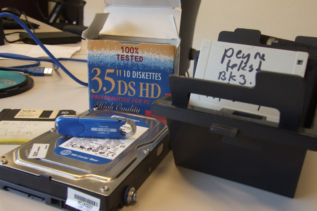Photograph of SATA hard disk, USB Flash drive and 3.5 floppy disks