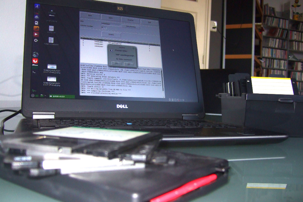 Photo of a laptop running the Ipmlab software. In the foreground is a removable USB floppy drive with some 3.5 inch floppies lying on top of it. To the right of the laptop is a vintage floppy storage box that contains more floppies.